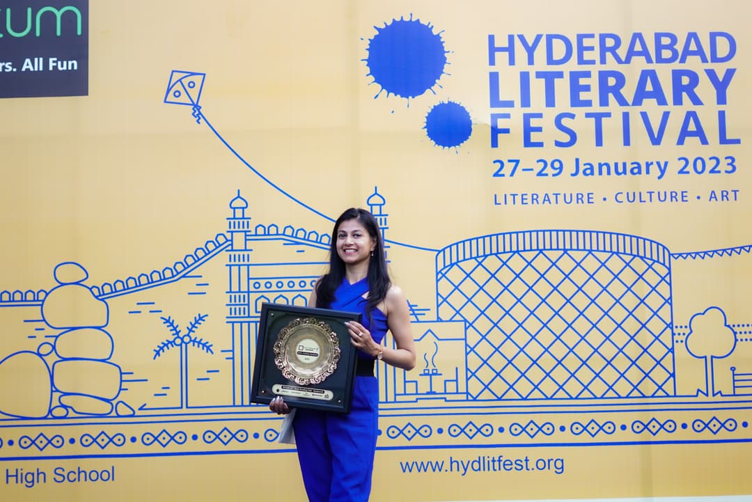 Neha Raj holding the Best Reading Club of India Award